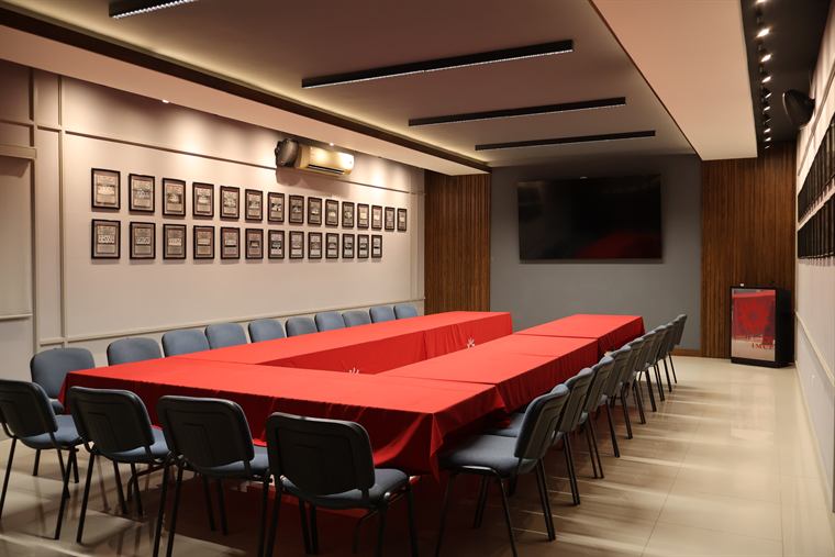 Aula Consejeros con mesas en herradura y pantalla al frente